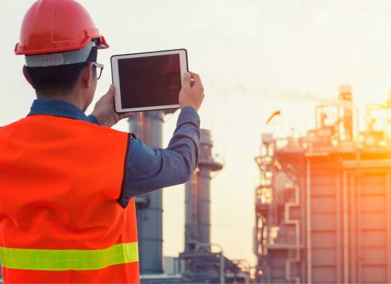 Engineer with a tablet at an industrial plant